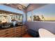 Bathroom with dual sinks, hardwood floors, granite countertops, and ocean view at 681 Casey Key Rd, Nokomis, FL 34275