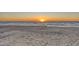 Beautiful beach with soft sand and gentle waves at sunset, creating a serene and picturesque scene at 681 Casey Key Rd, Nokomis, FL 34275
