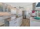 Modern white kitchen with stone countertops and island at 681 Casey Key Rd, Nokomis, FL 34275