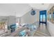 Bright open living room with ocean view, modern furnishings, and access to the outdoor deck at 681 Casey Key Rd, Nokomis, FL 34275