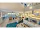Bright open living room with ocean view, modern furnishings, and access to the outdoor deck at 681 Casey Key Rd, Nokomis, FL 34275