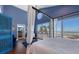 Bright, ocean view main bedroom with hardwood floors, four poster bed, and blue walls at 681 Casey Key Rd, Nokomis, FL 34275