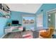 Office space with two desks, shelves, view of ocean, and bright blue walls at 681 Casey Key Rd, Nokomis, FL 34275