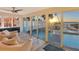Inviting sunroom featuring large glass windows that overlook the pool and beautiful ocean views at 681 Casey Key Rd, Nokomis, FL 34275