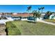 House with a well-maintained lawn and dock at 8 Island Dr, Treasure Island, FL 33706