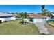 House with a well-maintained lawn and dock at 8 Island Dr, Treasure Island, FL 33706