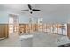 Renovation in progress: Bedroom with exposed framing and new flooring at 8 Island Dr, Treasure Island, FL 33706