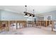Dining room undergoing renovation with exposed framing and new light fixture at 8 Island Dr, Treasure Island, FL 33706