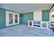 Large covered patio features an outdoor kitchen and ceiling fan at 8 Island Dr, Treasure Island, FL 33706