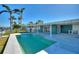 Stunning pool and home exterior view, showcasing the property's curb appeal and backyard oasis at 8 Island Dr, Treasure Island, FL 33706