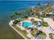 Aerial view of waterfront property with pool, lush landscaping, and boat slips at 888 Boulevard Of The Arts # 1705, Sarasota, FL 34236