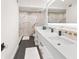 Large bathroom with double vanity, marble tile, and modern fixtures at 888 Boulevard Of The Arts # 1705, Sarasota, FL 34236