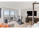 Bedroom with Peloton bike and access to balcony with water views at 888 Boulevard Of The Arts # 1705, Sarasota, FL 34236