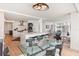 Modern dining area with glass table and kitchen views at 888 Boulevard Of The Arts # 1705, Sarasota, FL 34236