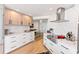 Modern kitchen with white and light wood cabinets and marble countertops at 888 Boulevard Of The Arts # 1705, Sarasota, FL 34236
