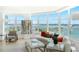 Living room with curved sofa and breathtaking water views at 888 Boulevard Of The Arts # 1705, Sarasota, FL 34236