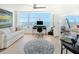 Home office with hardwood floors, large windows and a comfortable couch at 888 Boulevard Of The Arts # 1705, Sarasota, FL 34236