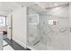 Walk-in shower with marble tile, glass enclosure, and built-in shelving at 888 Boulevard Of The Arts # 1705, Sarasota, FL 34236