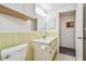 Bathroom with vanity, toilet, and access to another room at 916 Mohawk Rd, Venice, FL 34293