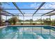 Inviting pool area with a tranquil water view at 1018 Deer Run, Venice, FL 34293