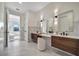 Modern bathroom with dual vanities and marble tile at 1173 Rotonda Cir, Rotonda West, FL 33947