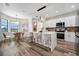 Modern kitchen with white cabinets, marble countertops, and an island at 1173 Rotonda Cir, Rotonda West, FL 33947