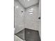 Modern shower with marble walls and a hexagonal floor tile at 1173 Rotonda Cir, Rotonda West, FL 33947