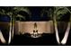 Landscaped backyard at night with palm trees and statuary at 13109 Palermo Dr, Bradenton, FL 34211