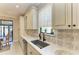 Modern kitchen with a farmhouse sink and custom cabinetry at 13109 Palermo Dr, Bradenton, FL 34211