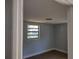 Simple bedroom with wood-look floors and neutral walls at 1317 Tennessee St, Plant City, FL 33563