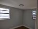 Simple bedroom with wood-look floors and neutral walls at 1317 Tennessee St, Plant City, FL 33563