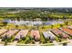 Beautiful aerial view of home, lush landscaping, and stunning lake view in a serene neighborhood at 1330 Still River Dr, Venice, FL 34293