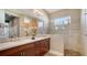 Double vanity bathroom with a large walk-in shower at 1330 Still River Dr, Venice, FL 34293