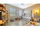 Charming bedroom with daybed, natural light, bamboo shelving, and playful decor at 1330 Still River Dr, Venice, FL 34293