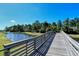 Scenic wooden bridge offers breathtaking views of the tranquil lake and surrounding nature at 1330 Still River Dr, Venice, FL 34293