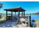 Relax by the water at the covered fishing pier complete with seating and beautiful lake views at 1330 Still River Dr, Venice, FL 34293