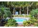 Secluded hot tub surrounded by tropical foliage for a private and tranquil experience at 1330 Still River Dr, Venice, FL 34293