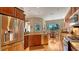 Bright kitchen with stainless steel appliances, granite counters, and adjacent breakfast nook at 1330 Still River Dr, Venice, FL 34293