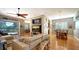 Open concept living area with hardwood floors, comfortable seating, and access to the lanai at 1330 Still River Dr, Venice, FL 34293