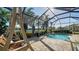 Screened-in pool is surrounded by lush landscaping with access to the water view at 1330 Still River Dr, Venice, FL 34293