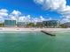 Aerial view of resort buildings and beach with a pier at 1581 Gulf Of Mexico Dr # 508, Longboat Key, FL 34228