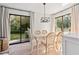 Bright dining room with glass-top table and chairs, near kitchen at 2204 Bahia Vista St # D1, Sarasota, FL 34239