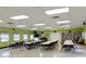 Spacious community room with tables, chairs, and a book collection at 2228 Canal Dr # D26, Bradenton, FL 34207