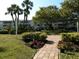 Landscaped courtyard with brick-paved pathways and picnic tables at 2228 Canal Dr # D26, Bradenton, FL 34207