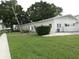 White building with lush landscaping, a sidewalk, and palm trees at 2228 Canal Dr # D26, Bradenton, FL 34207