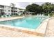 Inviting community pool with lounge chairs and patio area at 2228 Canal Dr # D26, Bradenton, FL 34207