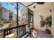 Relaxing screened porch with a bench and ceiling fan at 2300 Stickney Point Rd Rd # 104, Sarasota, FL 34231