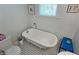 Charming bathroom with clawfoot tub, black and white tile floor, and decorative accents at 2325 Ixora Ave, Sarasota, FL 34234