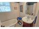 Classic bathroom with clawfoot tub, wood vanity, and black and white tile at 2325 Ixora Ave, Sarasota, FL 34234