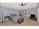 Spacious bedroom with light walls, ceiling fan, and ample closet space at 24911 Oakhaven Ct, Lutz, FL 33559